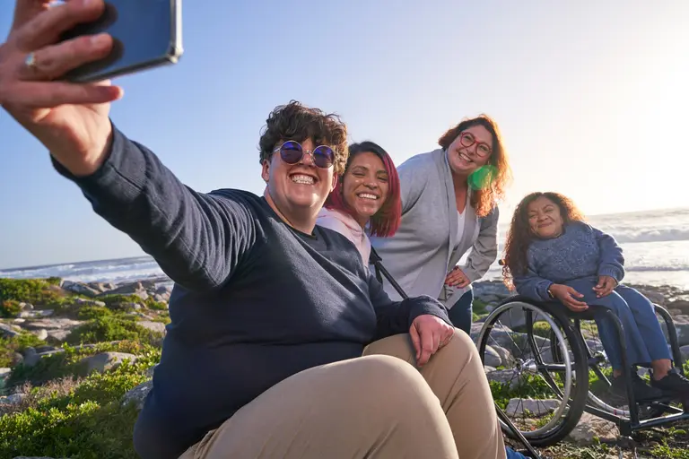 Group of friends outside by the beach taking a selfie